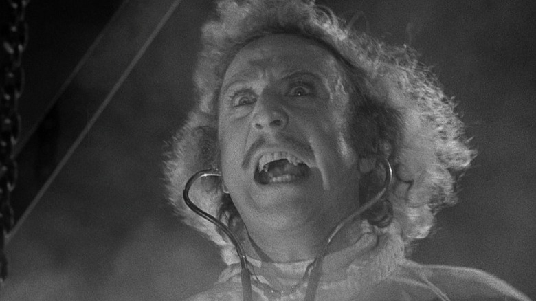 Gene Wilder as Dr. Frederick Frankenstein screaming wildly in lab attire in Young Frankenstein