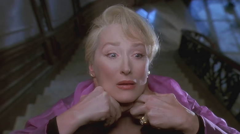 Madeline Ashton (Meryl Streep) being choked atop a tall staircase in Death Becomes Her (1992).