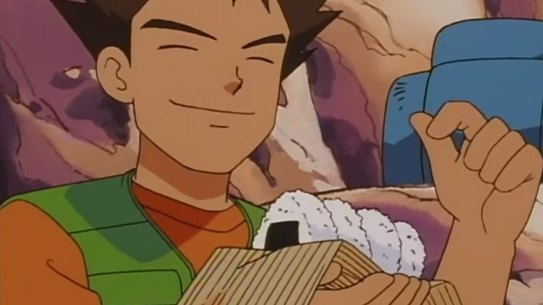 Brock holds a line of rice balls in Pokémon