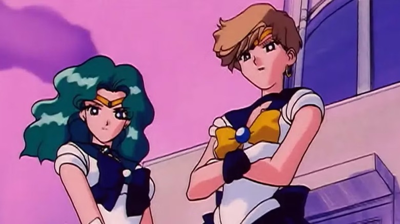 Sailors Neptune and Uranus stand together on a roof in Sailor Moon