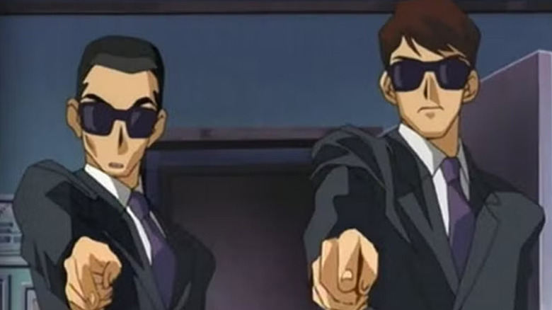 Two gunmen awkwardly point forward in Yu-Gi-Oh! Duel Monsters