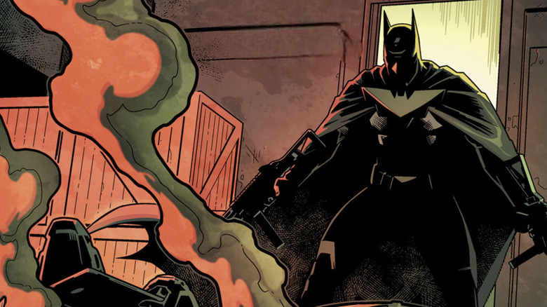 Batman wielding two guns in a warehouse
