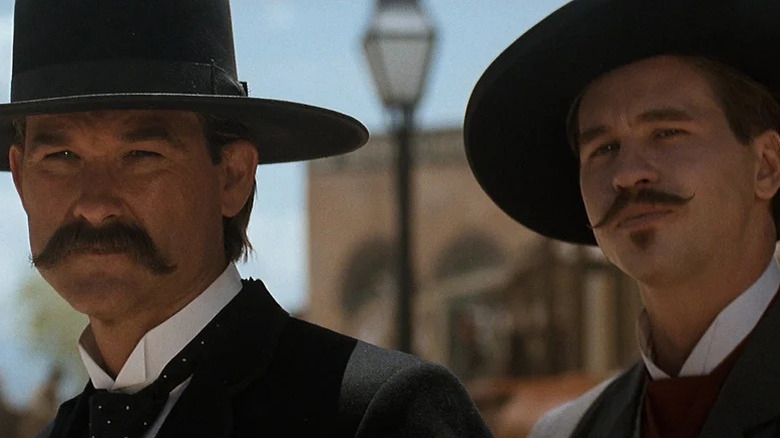 Wyatt Earp (Kurt Russell) and Doc Holliday (Val Kilmer) stare into the distance in Tombstone