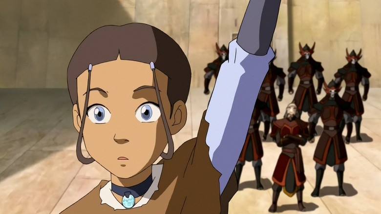 Avatar: The Last Airbender's Katara raises her hand, fire nation soldiers behind her