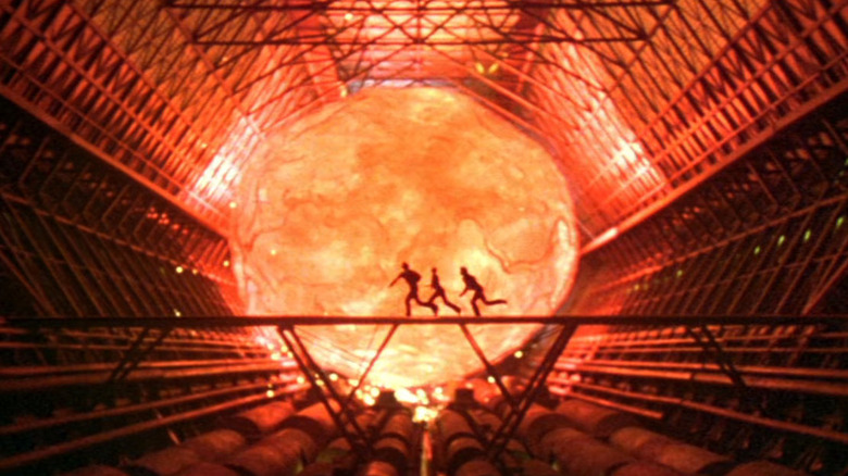 A fireball approaching some people running in The Black Hole