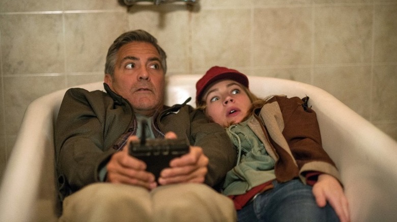 George Clooney as Frank and Britt Robertson as Casey hiding from androids in Tomorrowland
