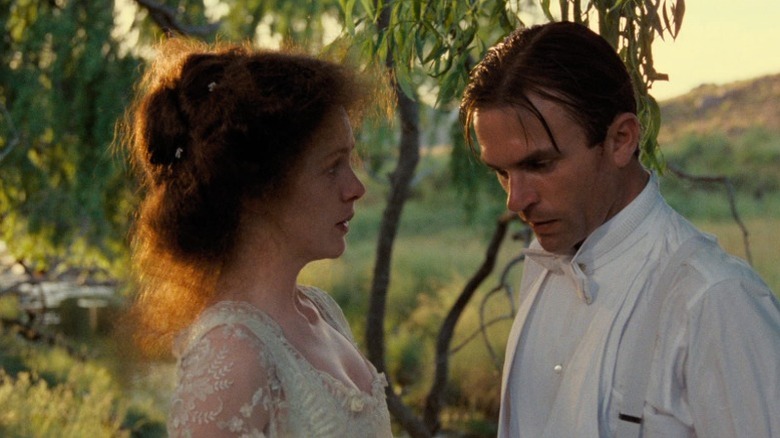 Judy Davis as Sybylla Melvyn and Sam Neill as Harry Beecham standing together by a river at dusk in My Brilliant Career