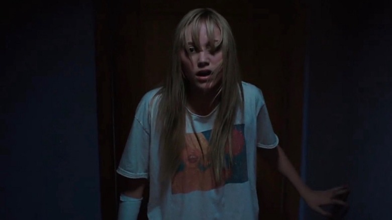 Maika Monroe walking slowly