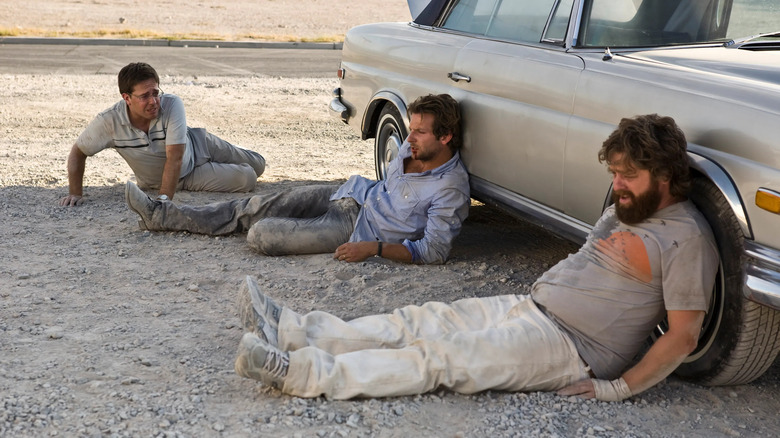 Guys leaning on car