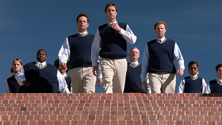 Bernard (Vince Vaughn), Mitch (Luke Wilson), and Frank (Will Ferrell) approach brick stairs flanked by their fraternity pledges in Old School