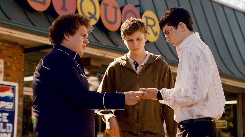 Seth (Jonah Hill), Evan (Michael Cera), and Fogell (Christopher Mintz-Plasse) talk outside of a liquor store in Superbad