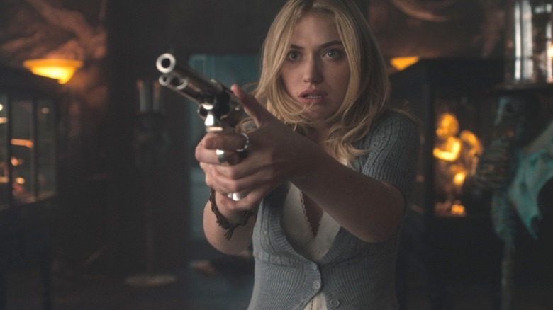 Imogen Poots holding a gun