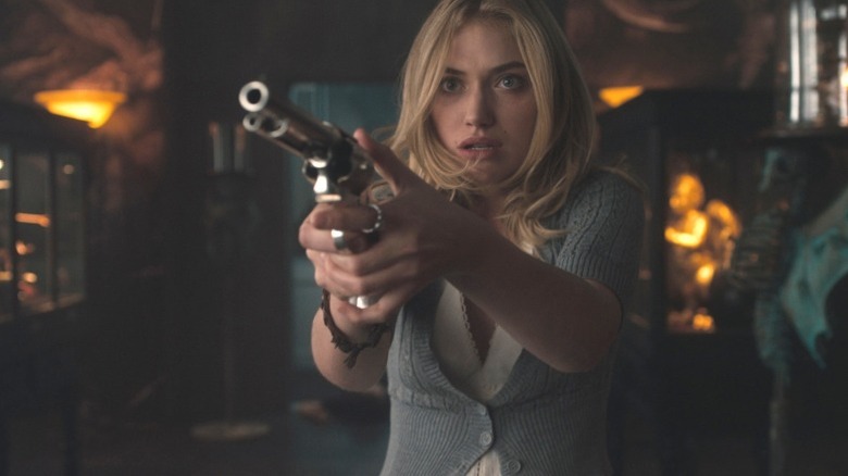Imogen Poots holding a gun