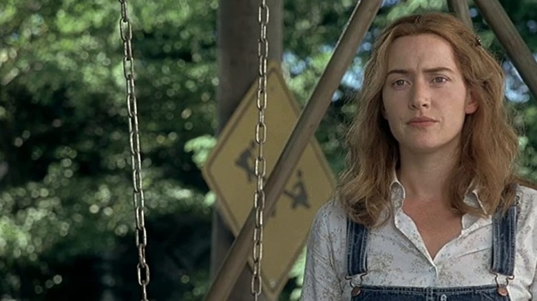 Kate Winslet standing near swing