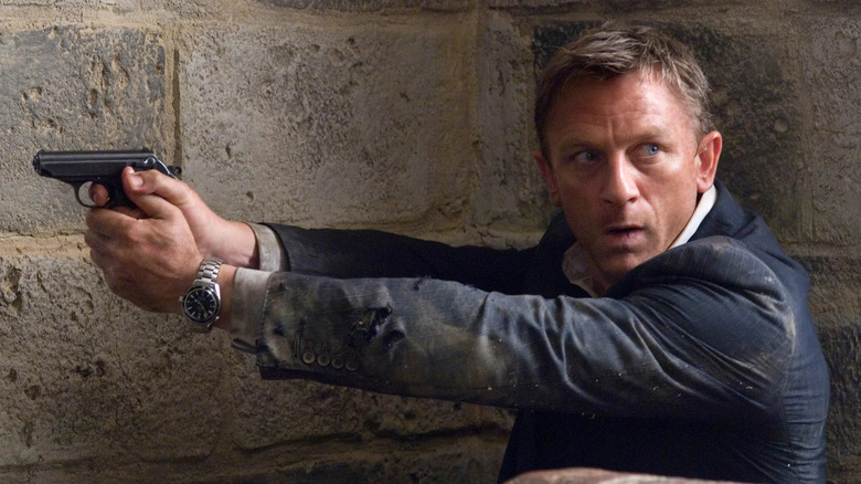 Daniel Craig as James Bond holding a gun and looking scared in Quantum of Solace