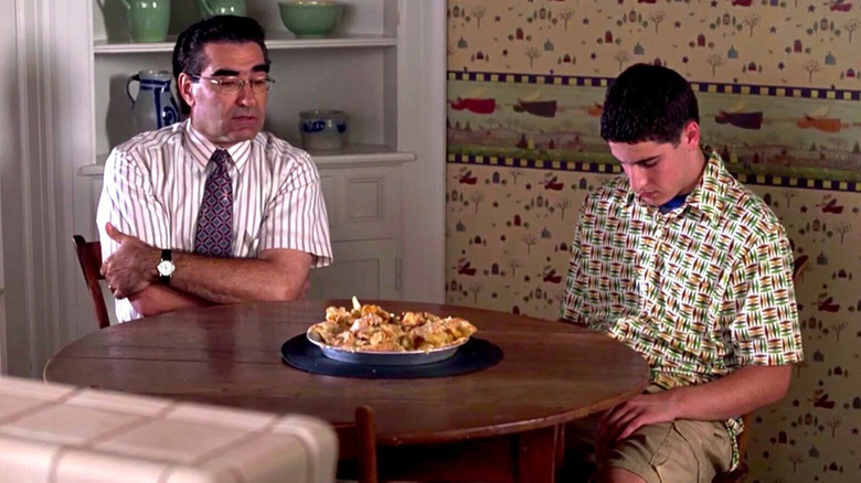 Jason Biggs as Jim Levenstein in shame next to his father (Eugene Levy) looking at a destroyed pie in American Pie.