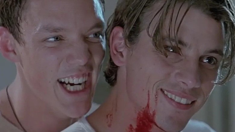 Matthew Lillard as Stu and Skeet Ulrich as Billy smile maniacally in Scream.