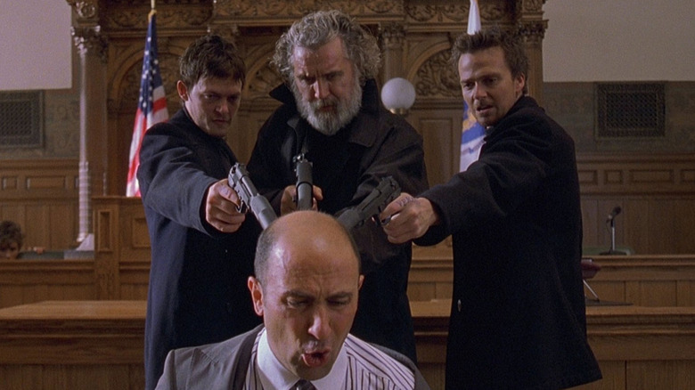 The Boondock Saints pointing guns at a man's head in a courtroom