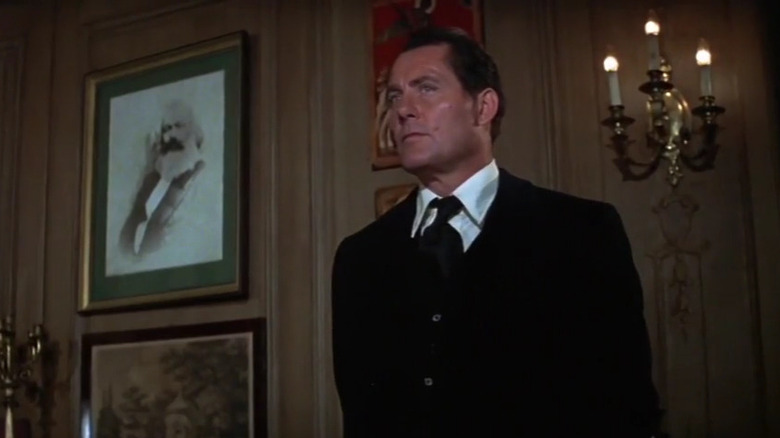 General Malenkov (Robert Shaw) standing in office in Avalanche Express