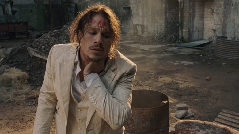 Doctor Parnassus (Heath Ledger) holding neck in The Imaginarium of Doctor Parnassus