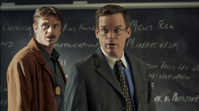 Lockhart and Holt standing in front of a blackboard