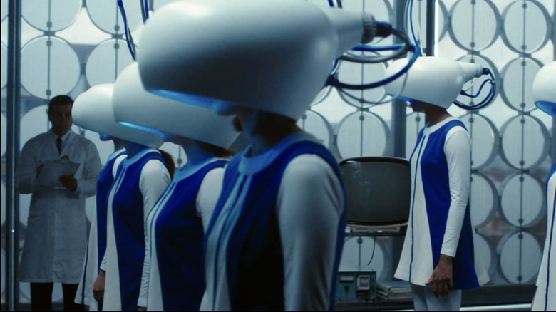 Women standing with machines on their heads