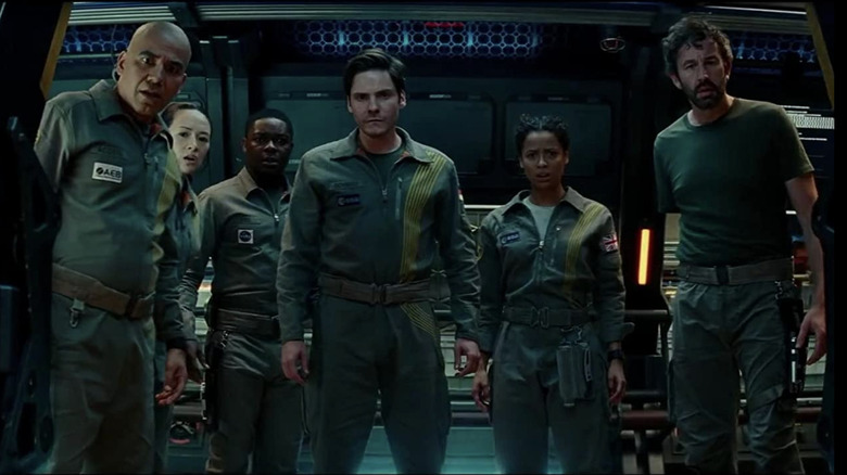 The crew standing in an open doorway