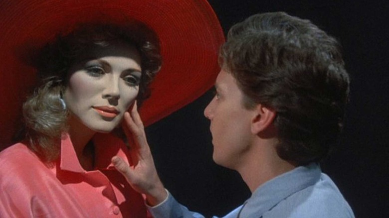 Andrew McCarthy as Jonathan Switcher touches the cheek of a mannequin that really does look like Kim Cattrall in Mannequin