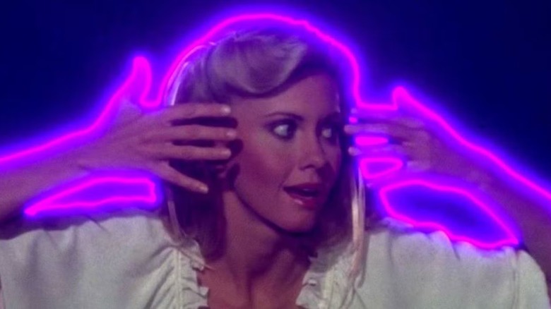 Olivia Newton-John as Terpsichore is lit up in neon like a NYC deli in Xanadu