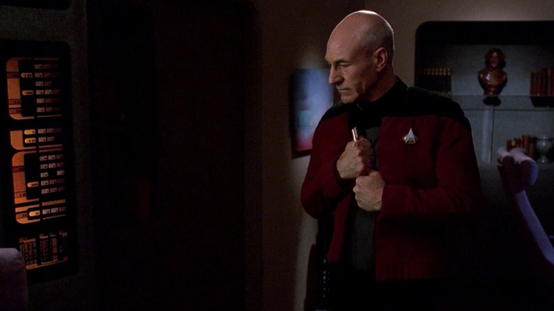 Jean-Luc Picard (Patrick Stewart) thoughtfully holds a flute in Star Trek: The Next Generation
