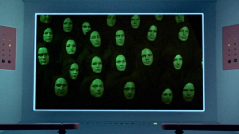 Mysterious faces look in at the Enterprise