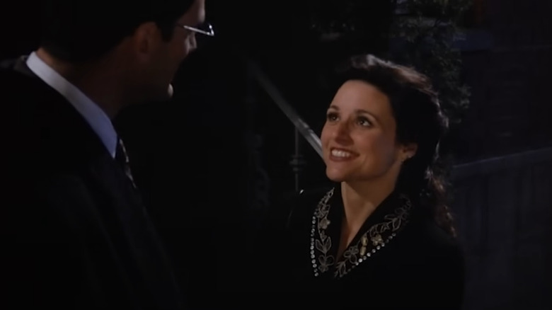 Julia Louis-Dreyfus as Elaine smiling at Robert Mailhouse as Robert in Seinfeld