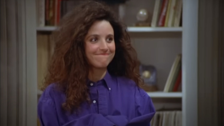 Julia Louis-Dreyfus as Elaine wearing Jerry's blue shirt in Seinfeld