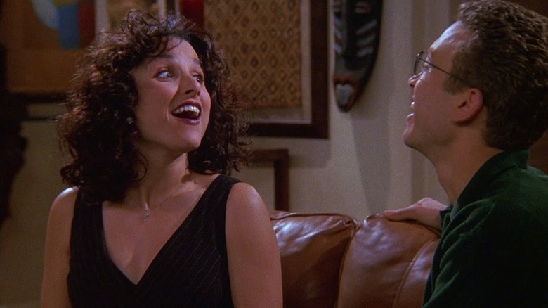 Julia Louis-Dreyfus as Elaine smiling at Samuel Bliss Cooper as Darryl in Seinfeld