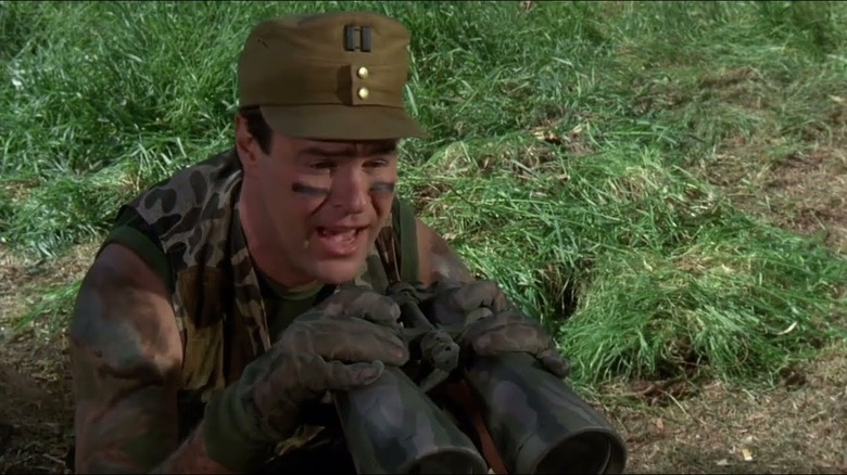 Tom Everett (Dan Aykroyd) wears camo and holds comedically large binoculars in Caddyshack II