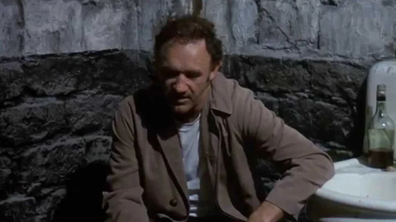 Popeye Doyle (Gene Hackman) leans against a dingy sink in French Connection II