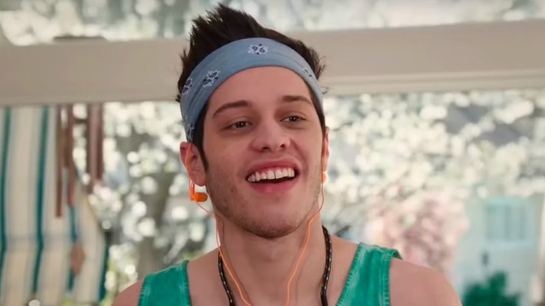 Pete Davidson as Chad in a headband, tanktop and ear buds on Saturday Night Live
