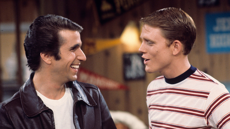 Henry Winkler as Fonzie and Ron Howard as Richie Cunningham share a look in Happy Days.