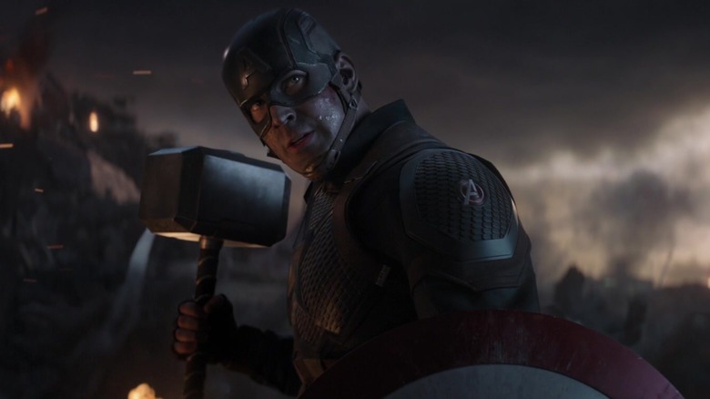 Chris Evans as Captain America holding his shield and Mjolnir in Avengers Endgame