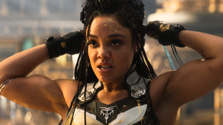 Tessa Thompson as Valkyrie tying Korg behind her head in Thor Love & Thunder