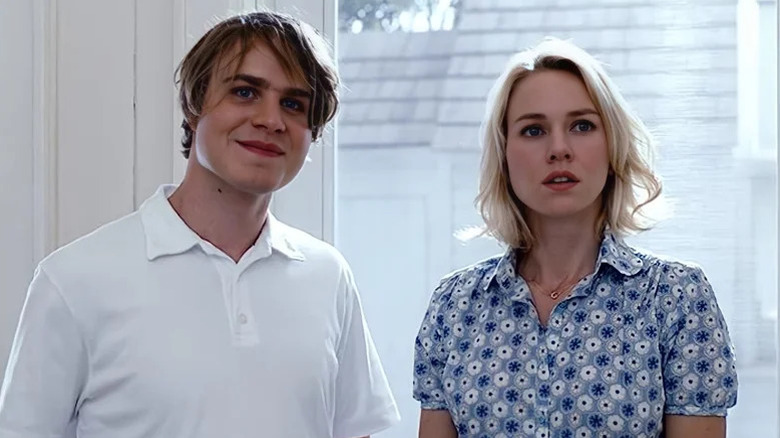 Brady Corbet as Peter smiling in white polo next to Naomi Watts as Ann in blue shirt in Funny Games
