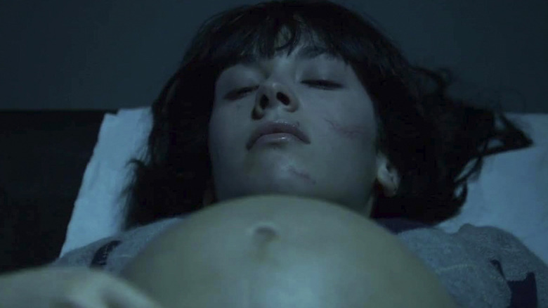 Alysson Paradis as Sarah in bed with her pregnant belly exposed in Inside