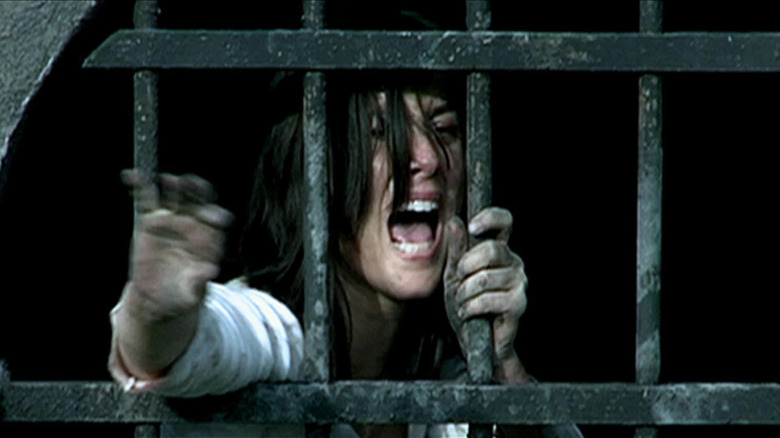 Olivia Bonamy as Clémentine reaching out from behind bars in Them