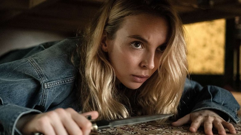 Jodie Comer as Villanelle holding a knife in Killing Eve