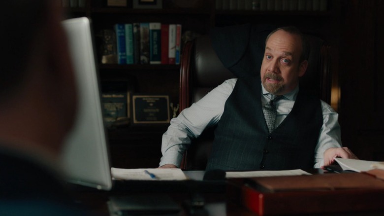 Paul Giamatti as Chuck Rhoades, Jr. sitting at his desk and speaking on Billions