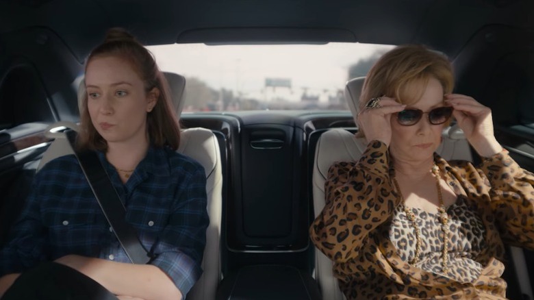 Hannah Einbinder as Ava Daniels and Jean Smart as Deborah Vance sitting awkwardly in the back seat of a car on Hacks