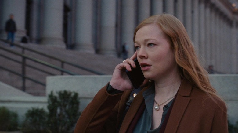 Sarah Snook as Shiv Roy standing on the street and talking on the phone on Succession