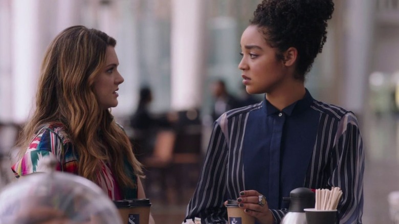 Meghann Fahy as Sutton Brady and Aisha Dee as Kat Edison looking at each other at a coffee shop on The Bold Type