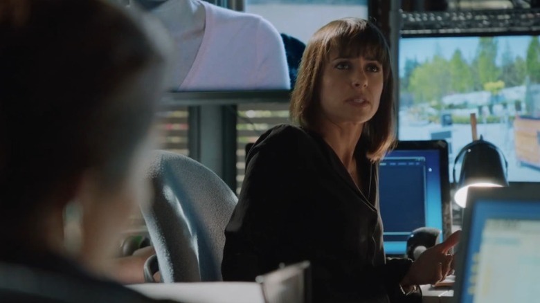 Constance Zimmer as Quinn King speaking while sitting at a desk surrounded by monitors on UnREAL