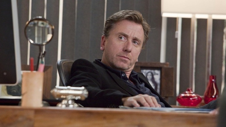 Cal Lightman (Tim Roth) sits quizzically at his desk in Lie to Me